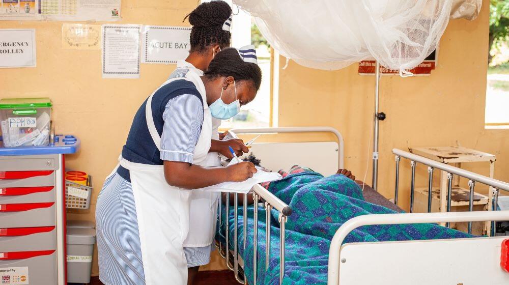 A midwife at Kabwe General Hospital conducting routine monitoring of maternal well-being for an expectant mother