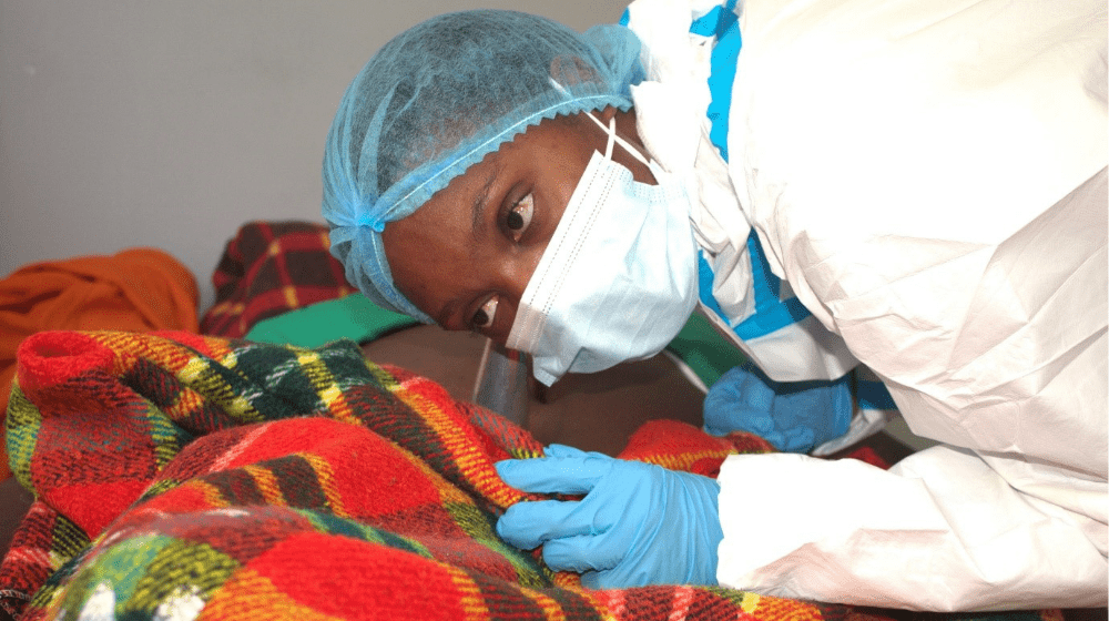 Midwife Cynthia Mandele tends to a pregnant woman diagnosed with cholera at the UNFPA-supported maternity ward within the cholera treatment center, providing critical care and support to ensure the well-being of both mother and unborn child