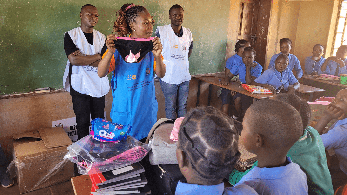 The adolescent focal person (nurse) for Kakwiya Rural Health Centre in Lusangazi district demonstrating how to use sanitary towels and pants in school and out of school adolescent girls. May 2025 @ChildLine LifeLine